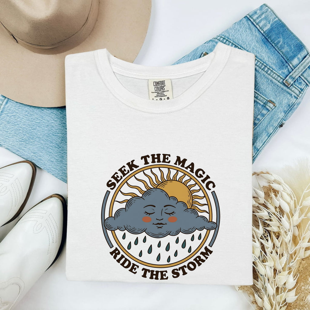 Seek the Magic Ride the Storm Tee – Inspirational Sun and Rain Graphic Tee