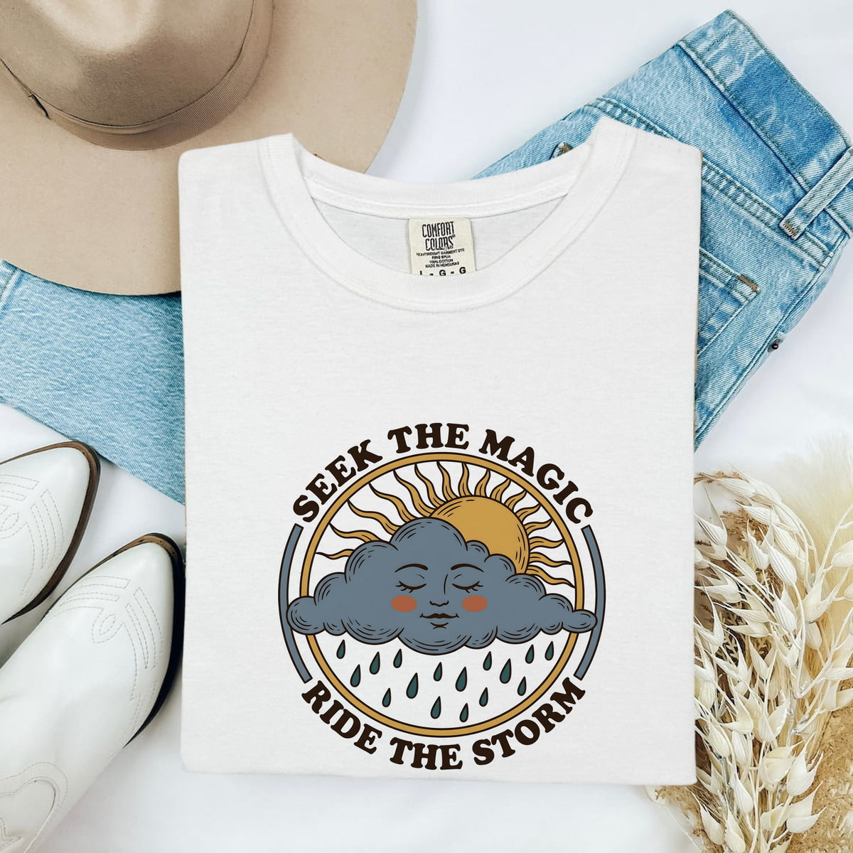 Seek the Magic Ride the Storm Tee – Inspirational Sun and Rain Graphic Tee